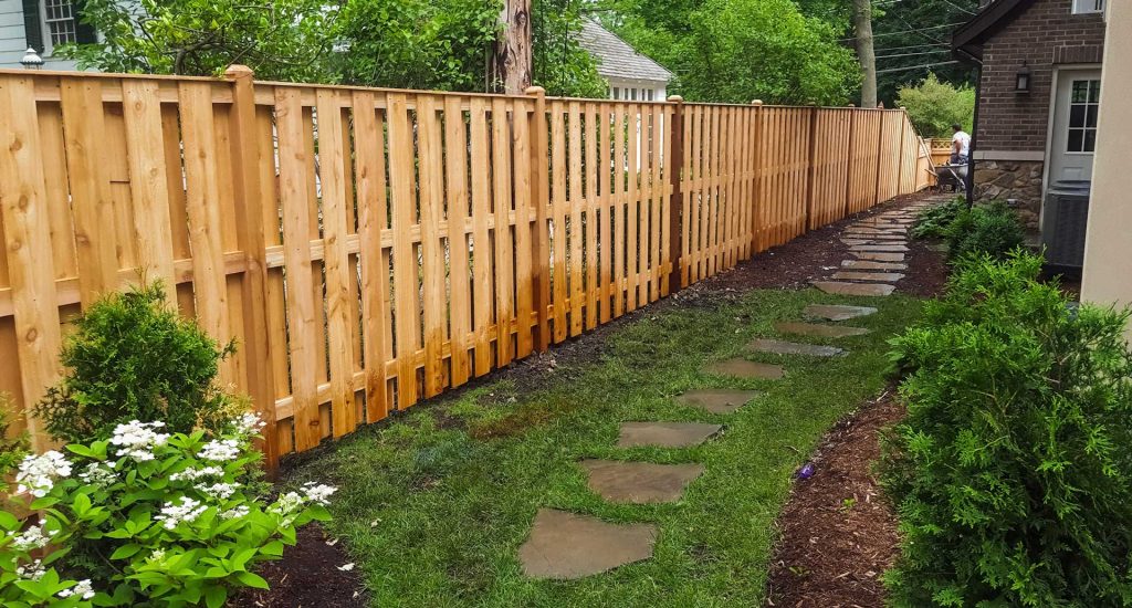 Wooden fence installed along the edge of a residential property