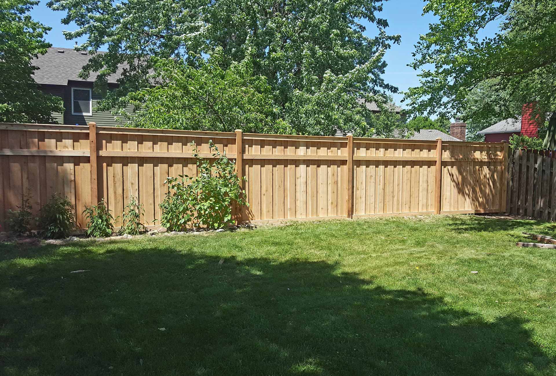 Wooden fence installed in backyard